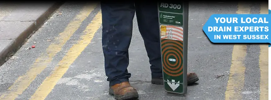 A DRAINTECH engineer using a sonde to locate the hidden drain